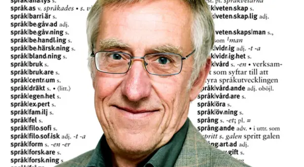 En äldre man med glasögon ler, med text från en ordbok som en bakgrund. Orden "språk" och "blomma ut" kan anas.