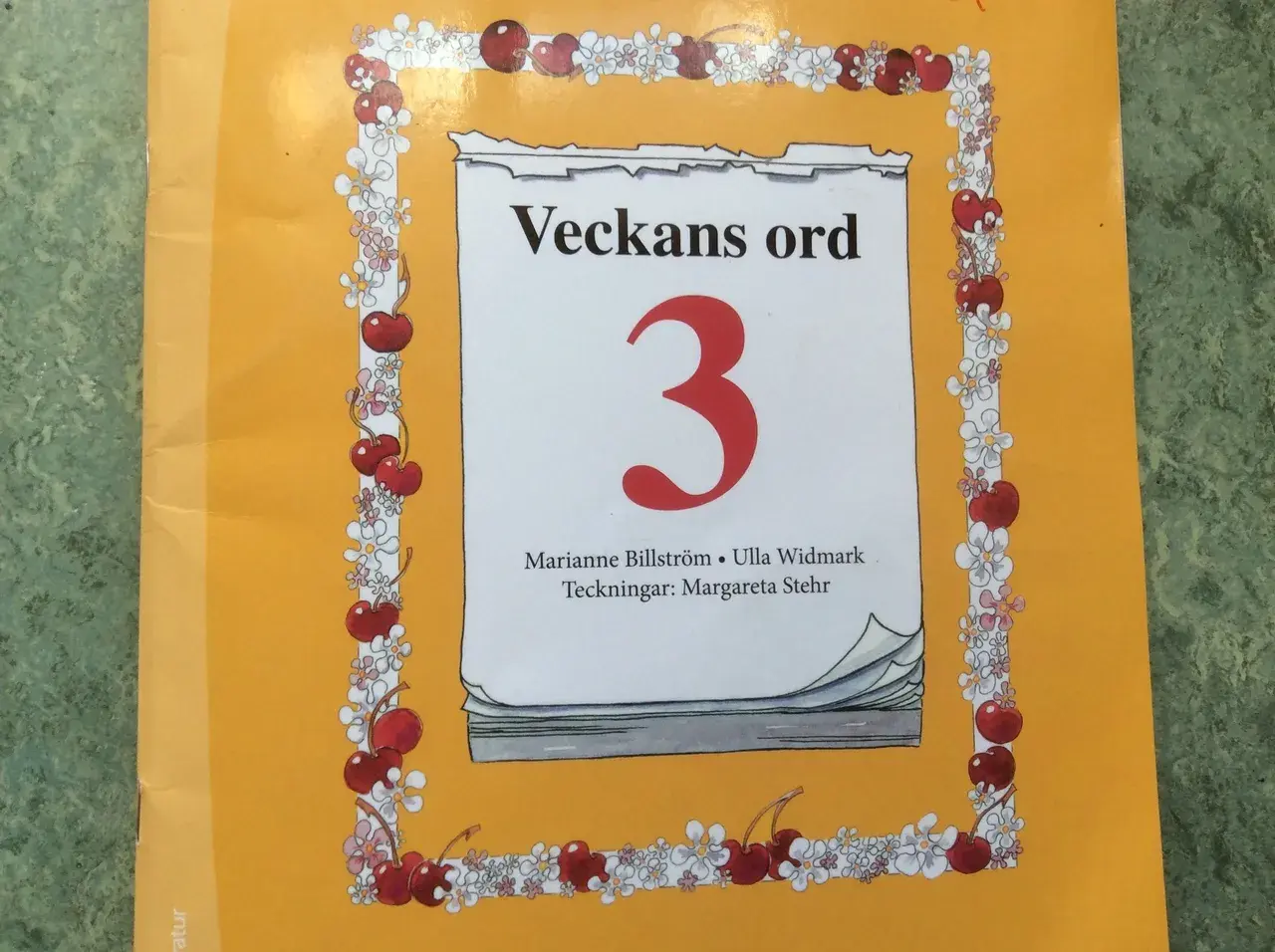 Cover of a book titled "Veckans ord 3" with a cherry and flower border.