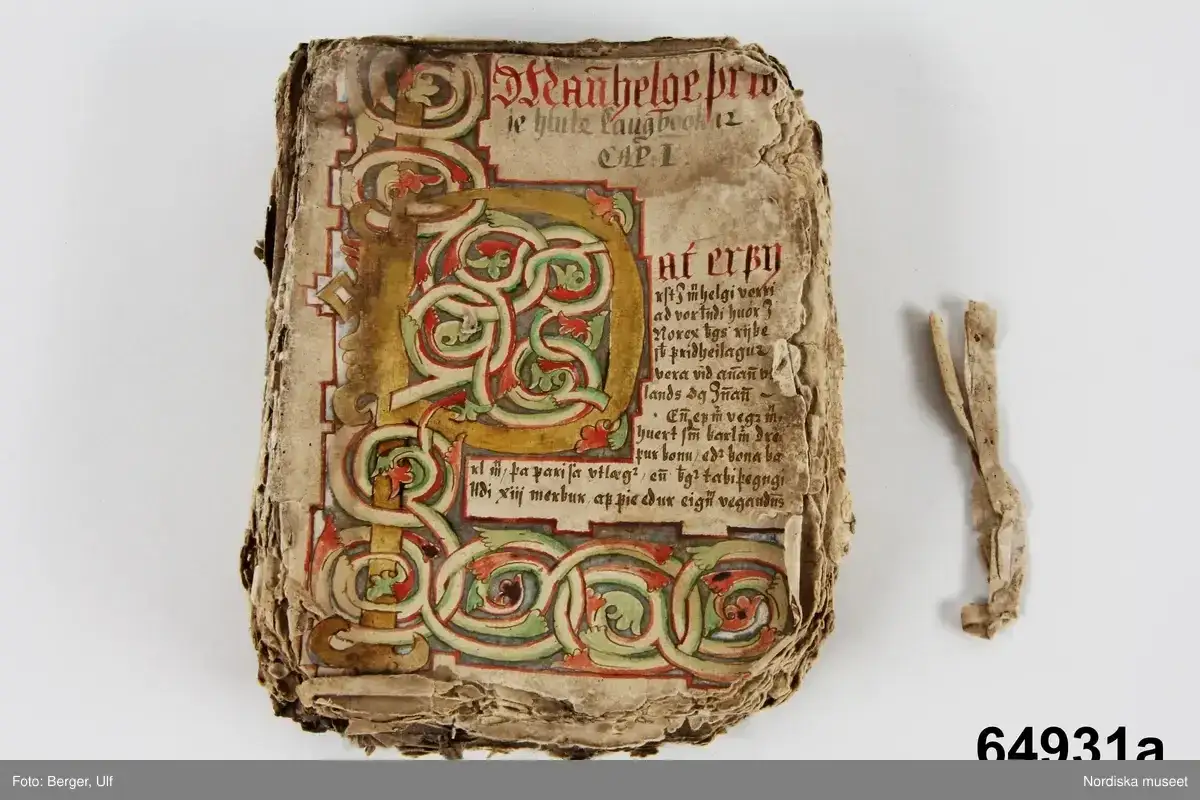 Gammal bok med utsmyckad initial. Texten ber&auml;ttar en historia, kanske en saga, om forntida h&auml;ndelser.